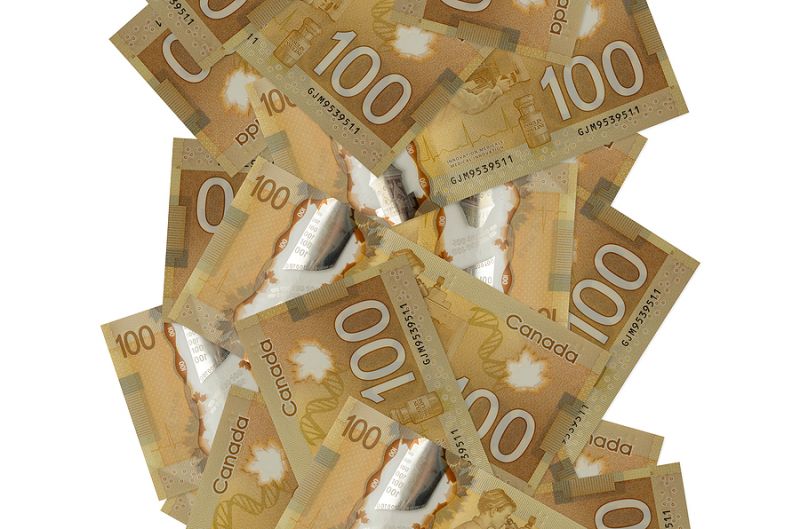 100 Canadian Dollars Bills Flying Down Isolated On White. Many B