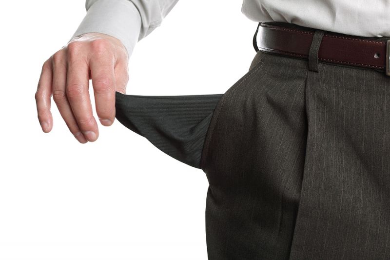 Businessman pulling out his empty pocket in despair