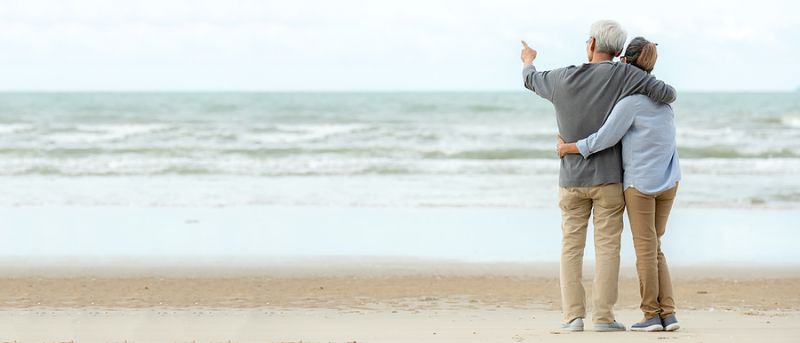 Asian Lifestyle Senior Couple Hug And Pointing On The Beach Happ